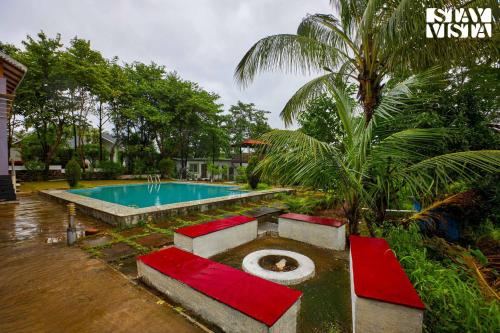 a pool with a toilet in the middle of a yard at Whispers of Green by VEO - Part of StayVista in Trimbak