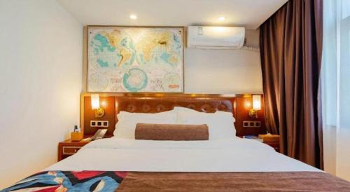 a bedroom with a large bed with a map on the wall at James Joyce Coffetel Guilin Railway Station Xiangbi Mountain Liangjiang Sihu Wharf in Guilin