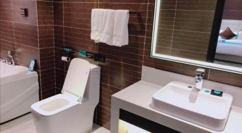 a bathroom with a toilet and a sink at Xana Hotelle Xi'an Zhonglou, Huimin Street Metro Station in Xi'an
