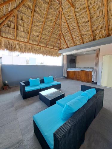 a room with blue pillows and couches in a building at Private house with two pools for up to 25 people in Atlacholoaya