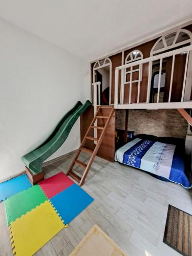 a room with two bunk beds and a slide at Private house with two pools for up to 25 people in Atlacholoaya