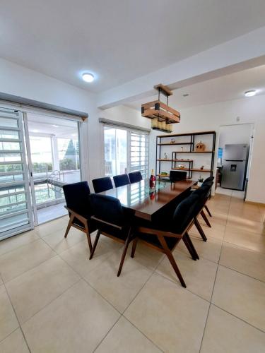 a dining room with a table and chairs at Private house with two pools for up to 25 people in Atlacholoaya