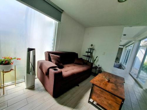 a living room with a couch and a coffee table at Private house with two pools for up to 25 people in Atlacholoaya