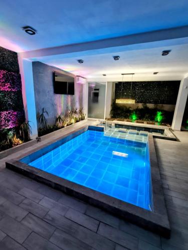 a swimming pool in the middle of a house at Private house with two pools for up to 25 people in Atlacholoaya