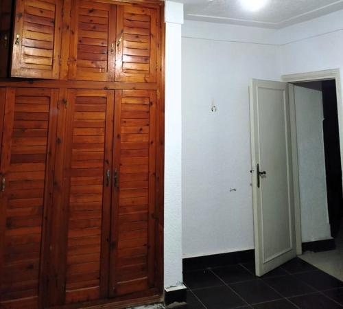 a room with a wooden closet and a door at Beautiful North Coast Family Villa with Pool, Just Minutes from the Sea in El Delr