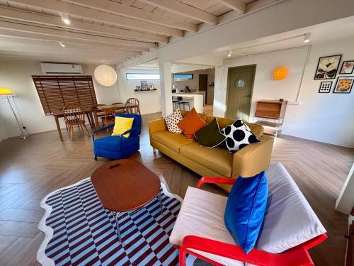 a living room with a couch and a table at City Center, Private Cozy house at Night Bazaar in Chiang Rai