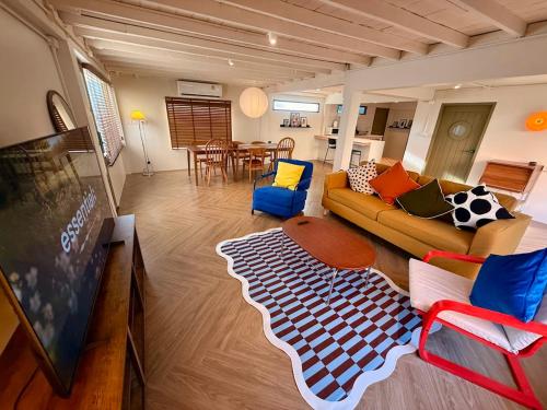 a living room with a couch and a table at City Center, Private Cozy house at Night Bazaar in Chiang Rai