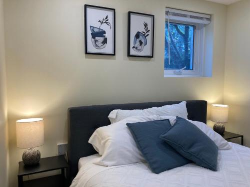 a bedroom with a bed with three pictures on the wall at Private Suite in Vancouver in Vancouver