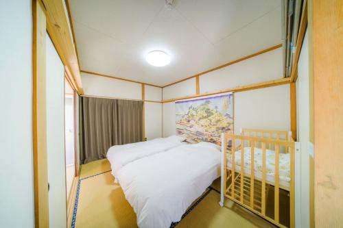 a small room with two beds and a crib at INARI - Vacation STAY 87349 in Takamatsu