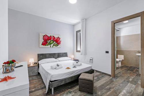 トッレ・ラピッロにあるPino Resort with shared poolの大きなベッドとバスルームのある寝室