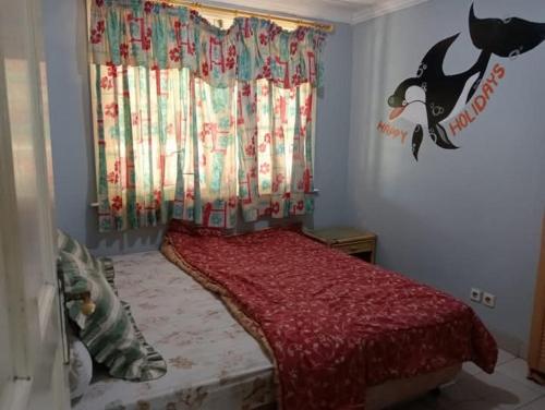 a bedroom with a bed with a red comforter at Lippo Carita 9270 in Carita