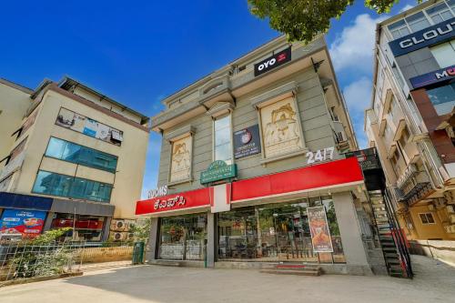 a store on a street in front of two buildings at Hotel O ALT pods in Bengaluru