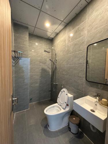 a bathroom with a toilet and a sink and a shower at Gạo Homestay-Hue in Hue