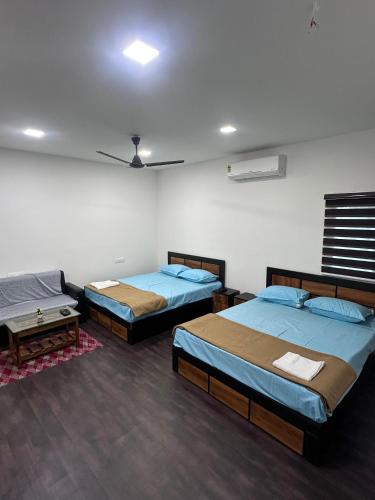 a room with three beds and a couch in it at skyblue in Jāmb