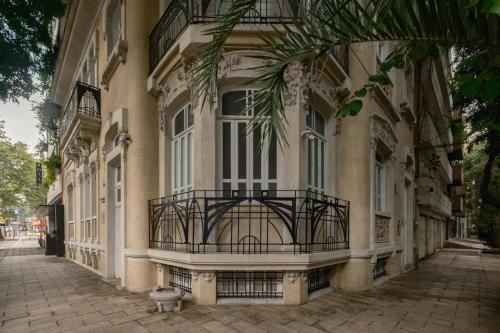 een gebouw met een balkon in een straat bij Hotel Casa Izel Roma Norte in Mexico-Stad