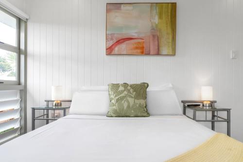 a bedroom with a large white bed with two side tables at 'Perfect Pool House' Idyllic Tropical Retreat in Edge Hill