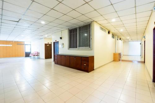 an empty hall with a large room with a large window at At Gate Suvarnabhumi Airport - แอท เกท สุวรรณภูมิ in Ban Khlong Prawet