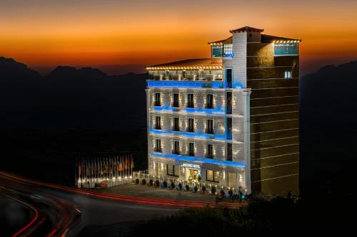 a lit up building at night with lights on at Petra Bermudez Hotel in Wadi Musa