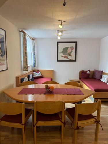 a room with a table and chairs and a couch at Appartement Schneider in Sankt Anton am Arlberg
