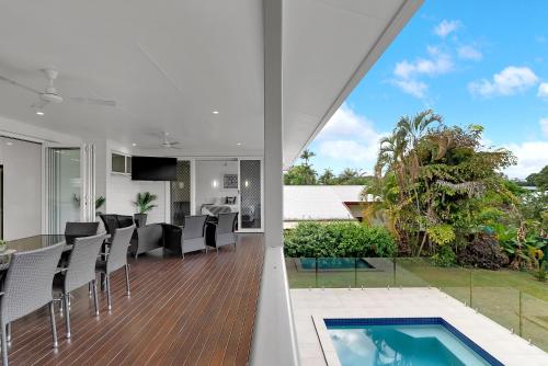 an open kitchen and dining room with a pool in a house at 'Perfect Pool House' Idyllic Tropical Retreat in Edge Hill