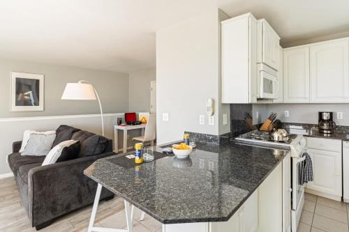 a kitchen and living room with a table and a couch at The Cayucan Bungalows by AvantStay Pet-Friendly Getaway Steps from Cayucos State Beach in Cayucos