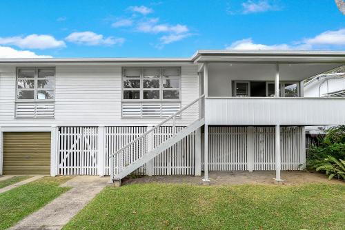 a white house with a white fence in front of it at 'Perfect Pool House' Idyllic Tropical Retreat in Edge Hill