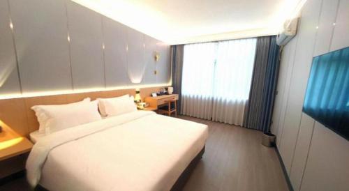 Katil atau katil-katil dalam bilik di Zhenxing Hotel