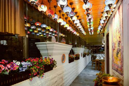 a store with a row of vases and flowers at Petra Bermudez Hotel in Wadi Musa