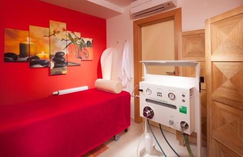 a red room with a bed and a machine at Francis Palace in Františkovy Lázně