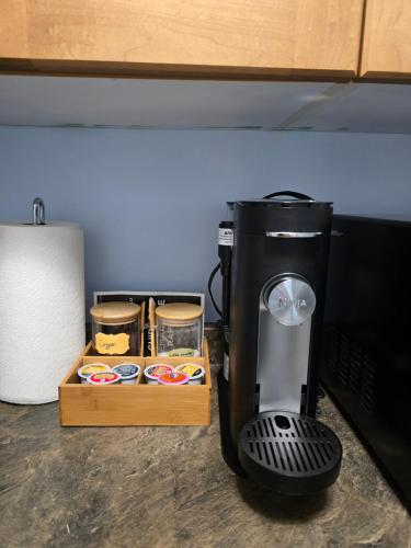 a coffee maker sitting on a counter next to a microwave at Private basement suite in Langley