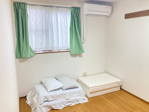 山口市にあるシャルマン寺田 アパート1室貸切 素泊まり最大6人宿泊可能 4名様まで同一料金のベッドと窓のある小さな部屋