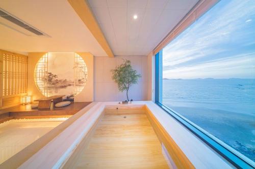 a large room with a pool and a large window at Yeonhwamoon Hotel Byeonsan in Buan