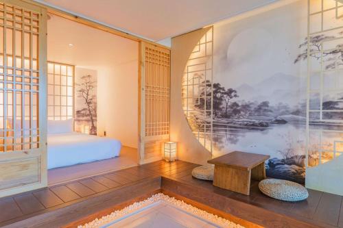 a room with a bed and a table at Yeonhwamoon Hotel Byeonsan in Buan