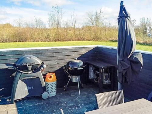 a grill and smoker on top of a patio at Luxury Lakeside Retreat - By Traum Ferienwohnungen in Ansager
