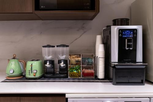a kitchen counter with a coffee maker and a toaster at The Central Hongdae in Seoul