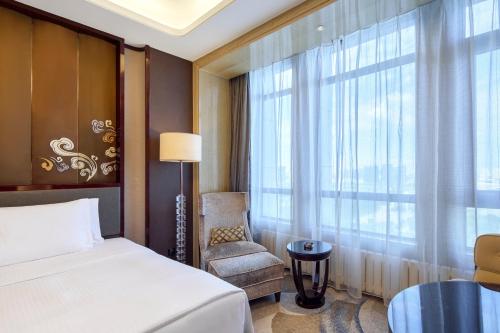 Ένα ή περισσότερα κρεβάτια σε δωμάτιο στο Wanda Realm Yinchuan