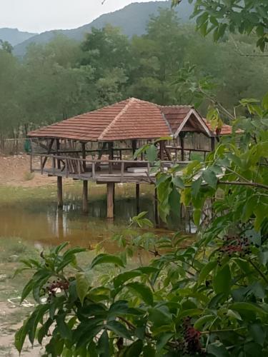 a group of houses on a dock in the water at Etno selo Srna in Kalna