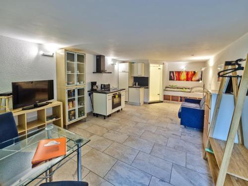 a large living room with a tv and a kitchen at Gemütliche Wohnung in Hellenthal in Hellenthal