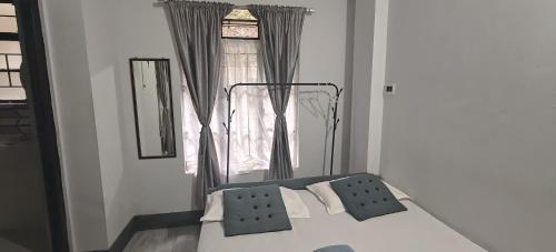 a bed in a room with a window at Harry's Homestay in Shillong