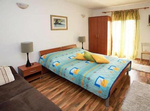a bedroom with a bed and a couch at Apartments K Supetar in Supetar
