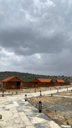 a large building with a group of buildings at Jabal Hatt Resthouse in Khawr Zammah