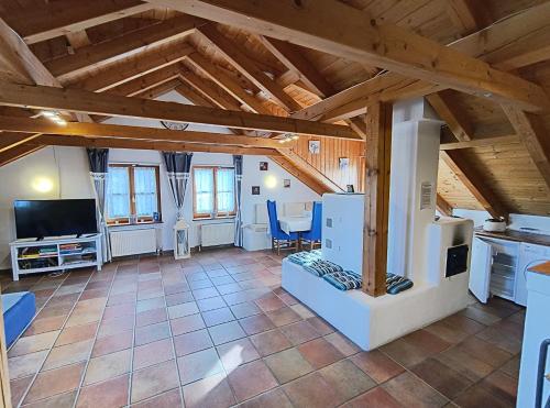 a kitchen and living room with wooden ceilings at Ferienwohnung zum Forsthaus mit Sauna in Oberviechtach