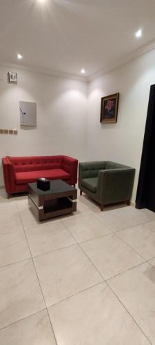 a living room with two couches and a table at وحدة سكنية سوبر لوكس in Quai
