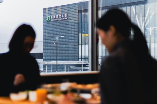 two women sitting at a table eating food at Hotel La'gent Plaza Hakodate Hokuto in Hokuto