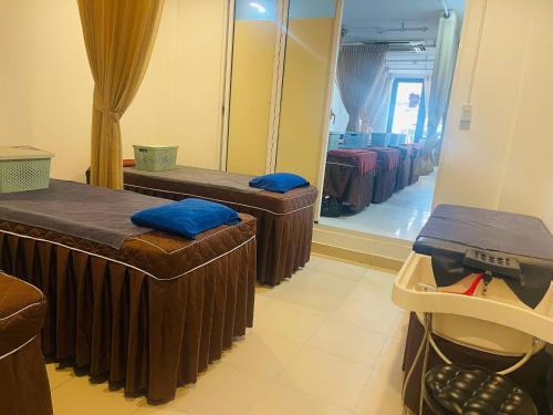 a room with two beds and a mirror at Lanxy Hotel Nha Trang in Nha Trang