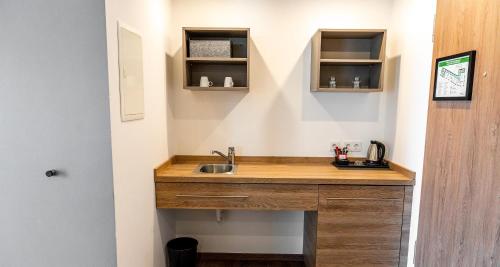 a kitchen with a sink in a room at Best Western Plus Hotel Ostertor in Bad Salzuflen