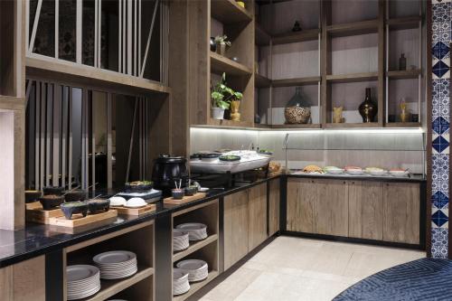 a kitchen with plates and dishes on display at Hilton Guadalajara Midtown in Guadalajara