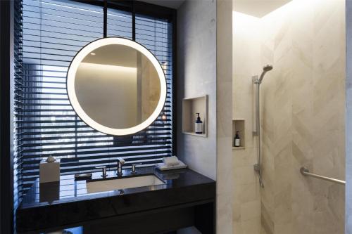 a bathroom with a sink and a mirror at Hilton Guadalajara Midtown in Guadalajara