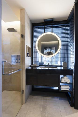 a bathroom with a sink and a mirror at Hilton Guadalajara Midtown in Guadalajara