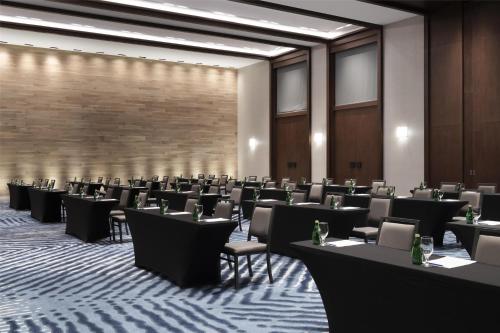 a room with rows of tables and chairs at Hilton Guadalajara Midtown in Guadalajara